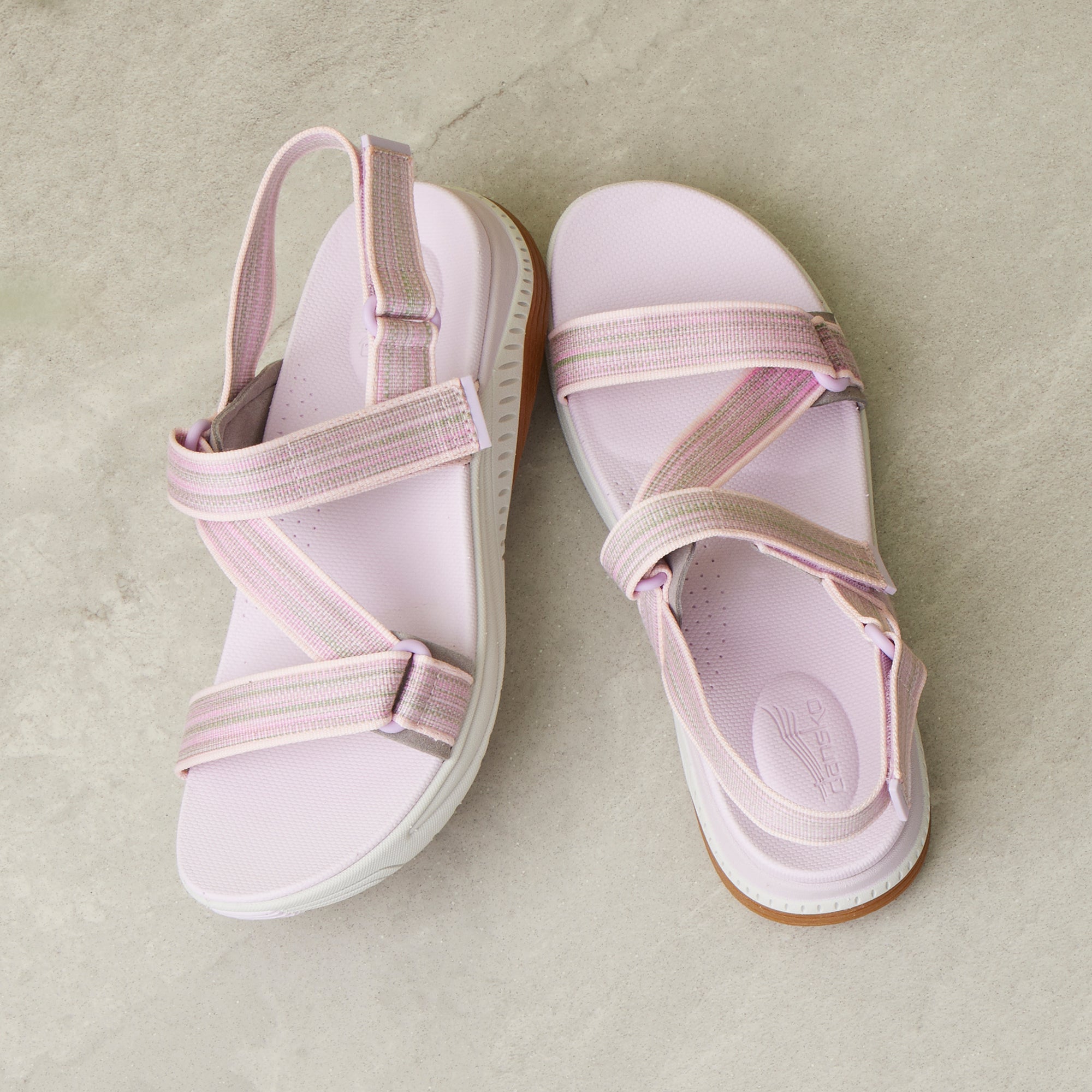 A detailed footbed and strap image of pink walking sandals.
