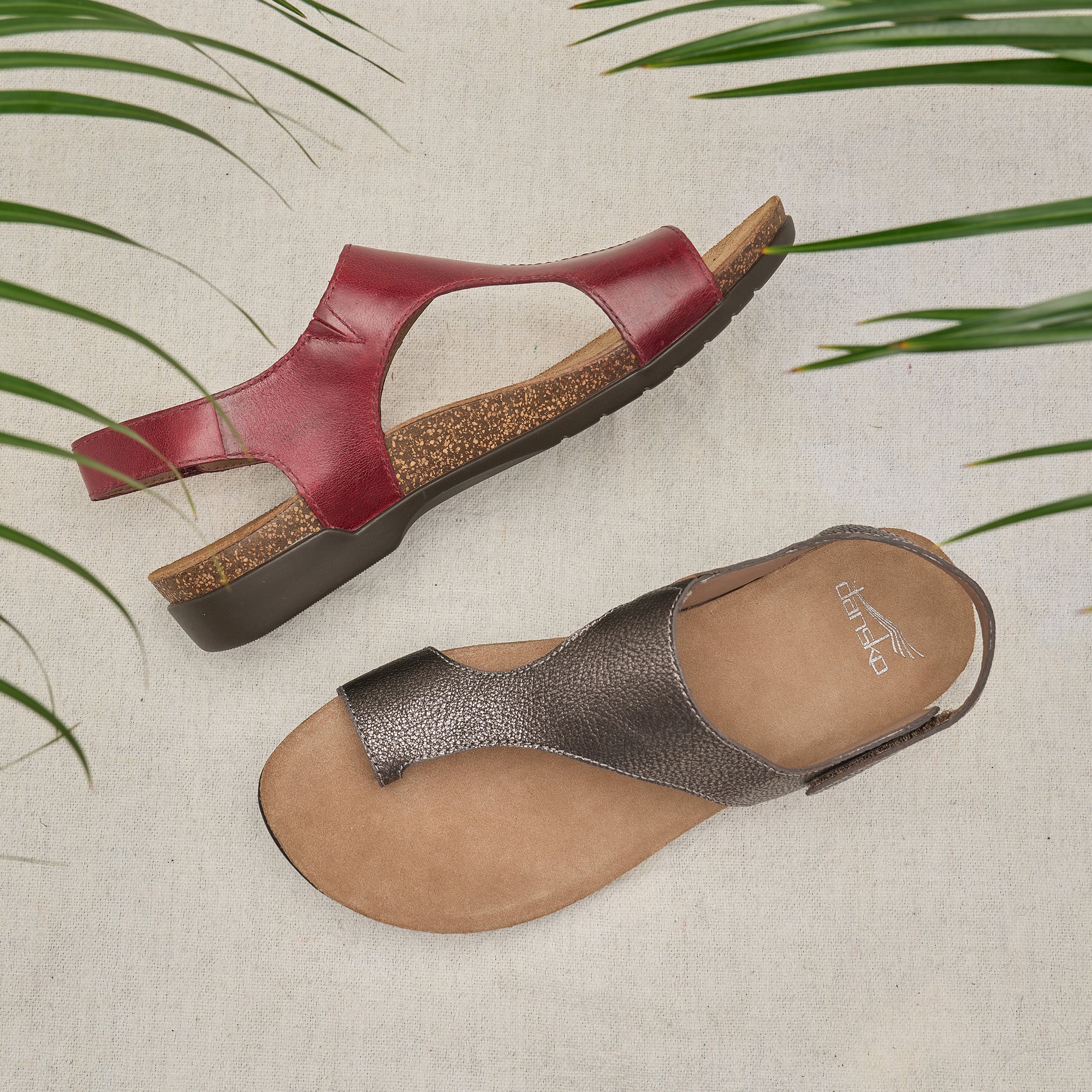 Two new colors of a flat leather sandal, metallic and cinnabar, shown stylishly.