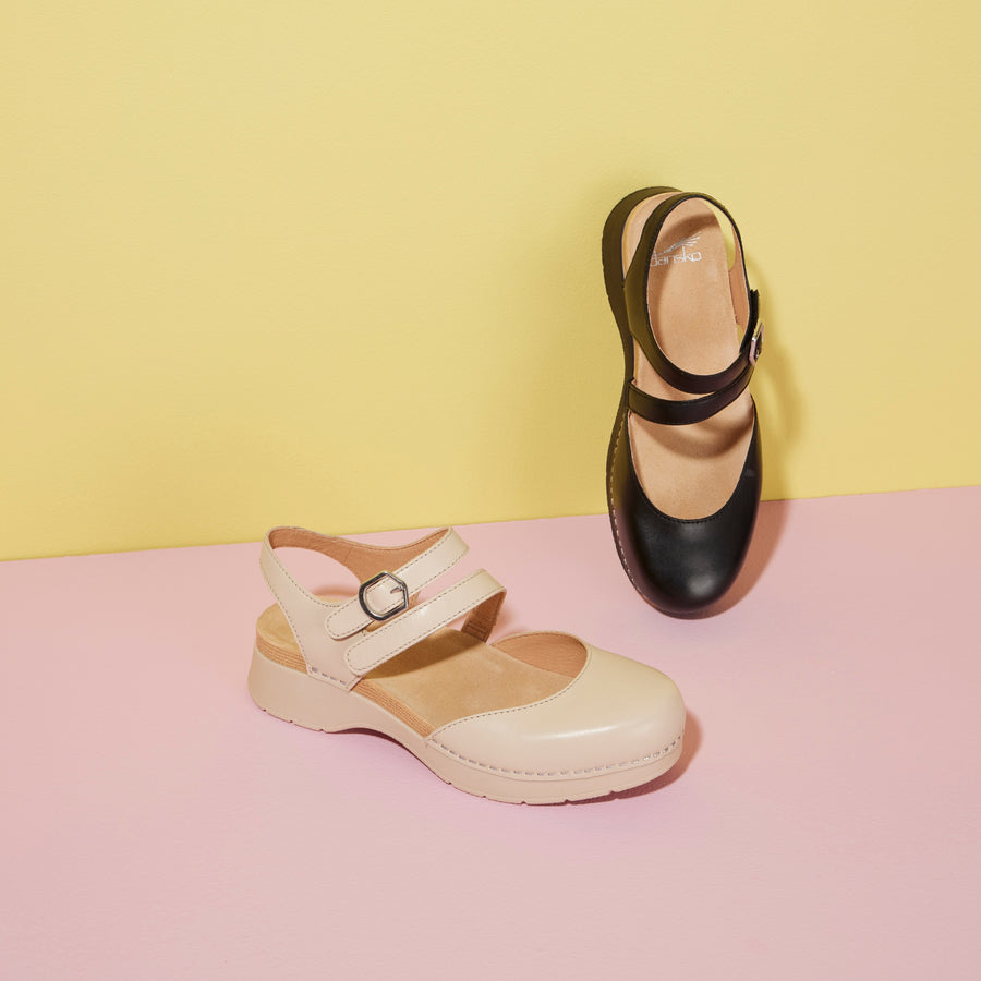 A flatform Mary Jane shown in black and tan.