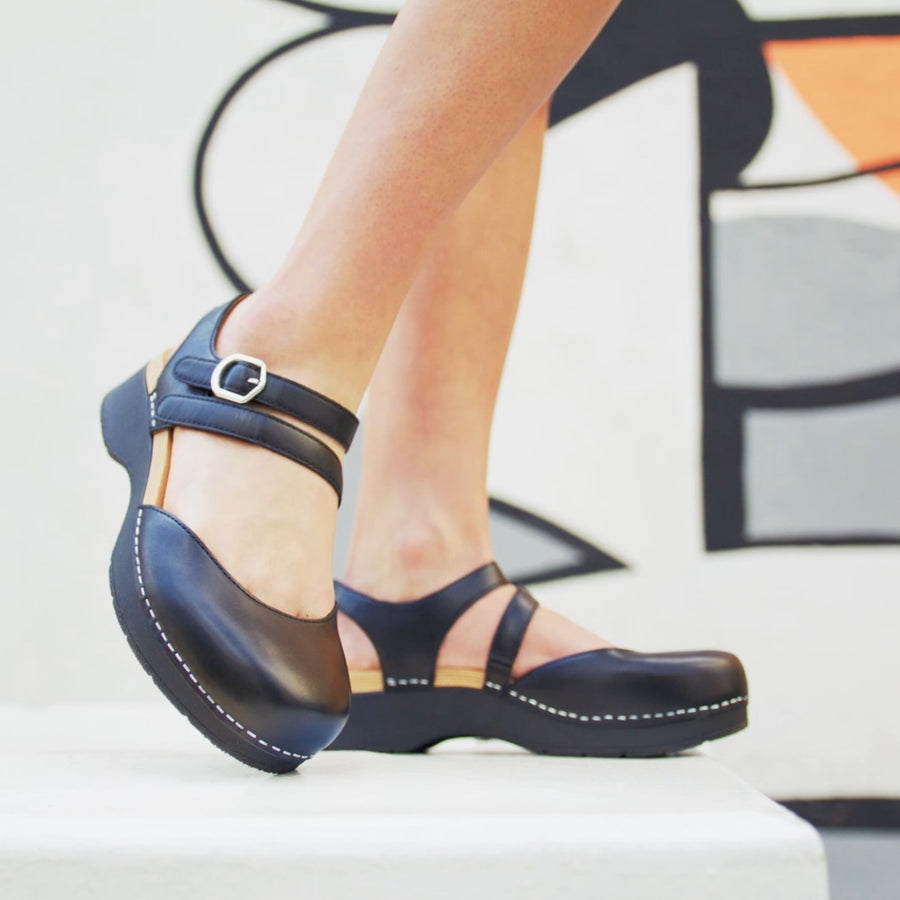 Black flatform Mary Janes shown on foot for style and fit.