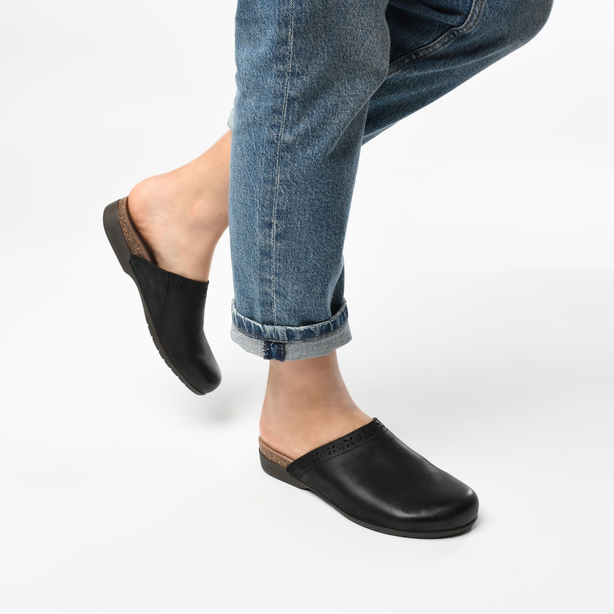 Black mules shown on foot.