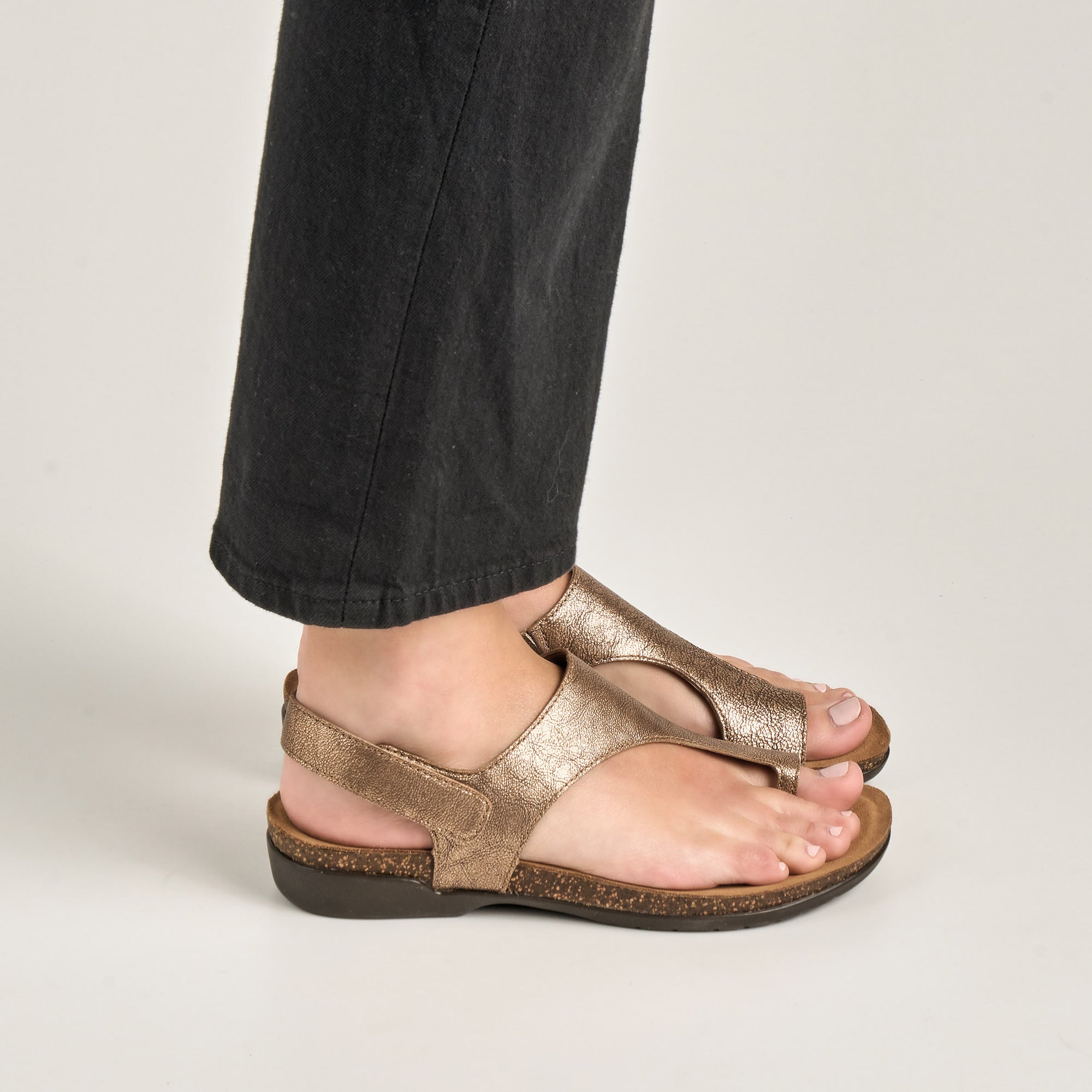 Close up of metallic bronze sandals.