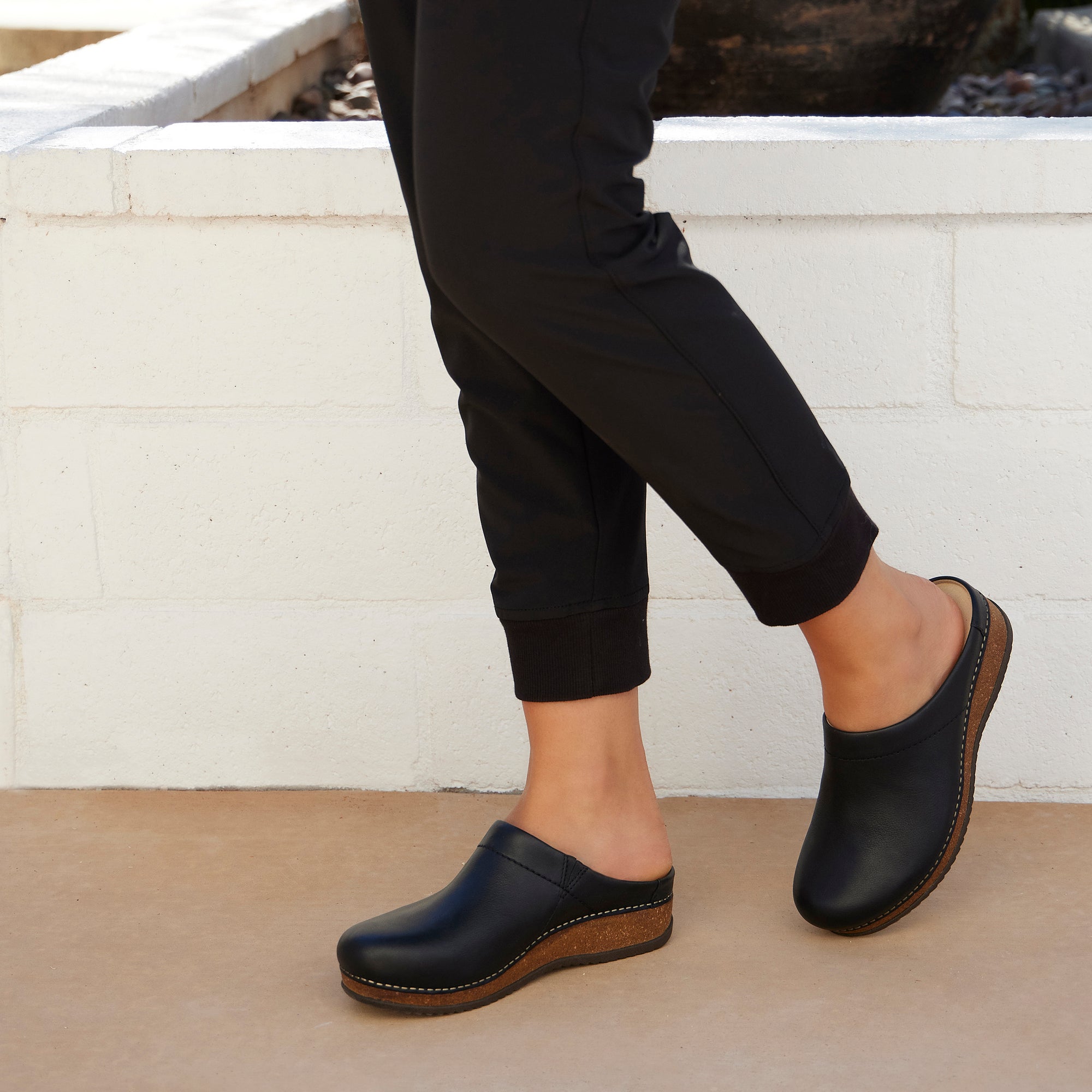A black mule clog with a cork-based outsole.