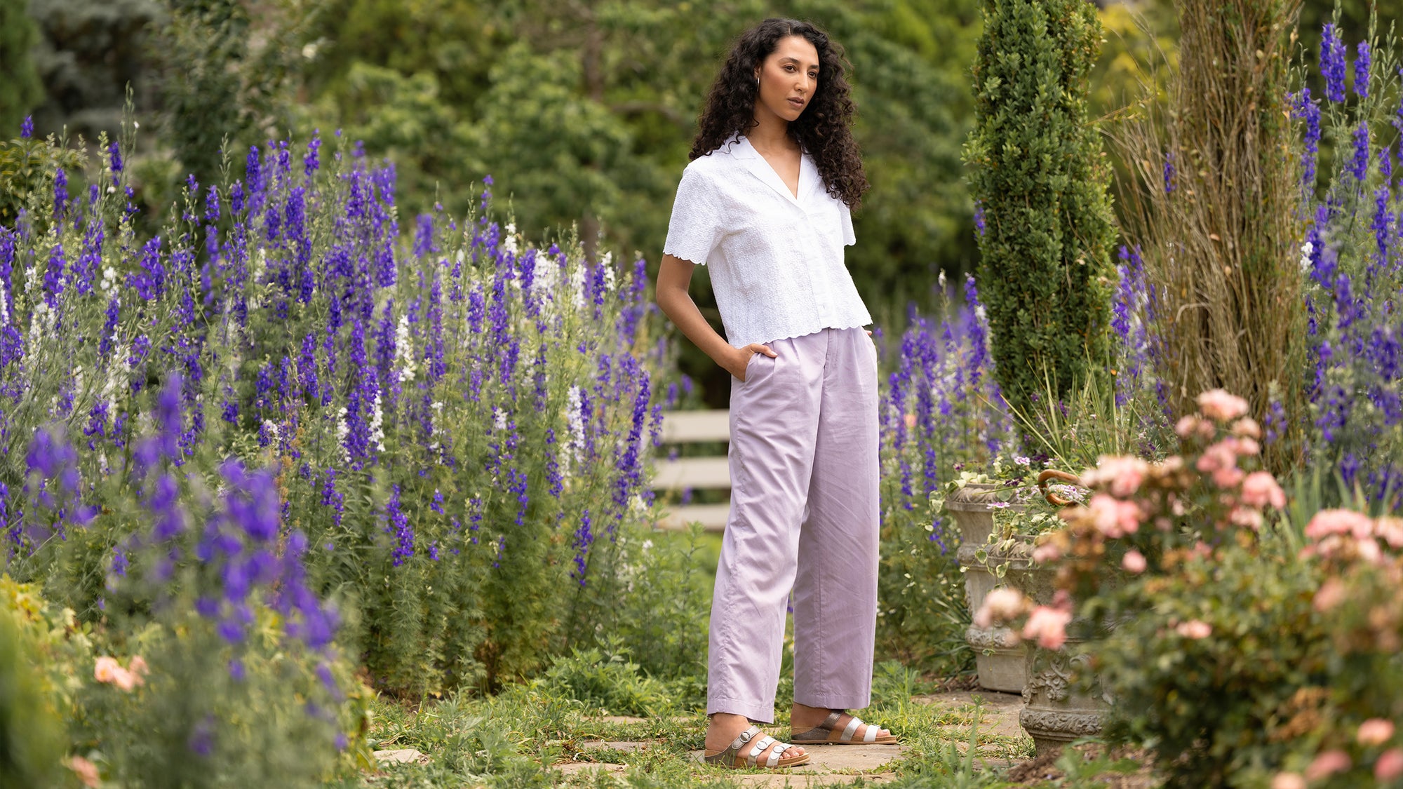 Girl in garden wearing metallic sandals.