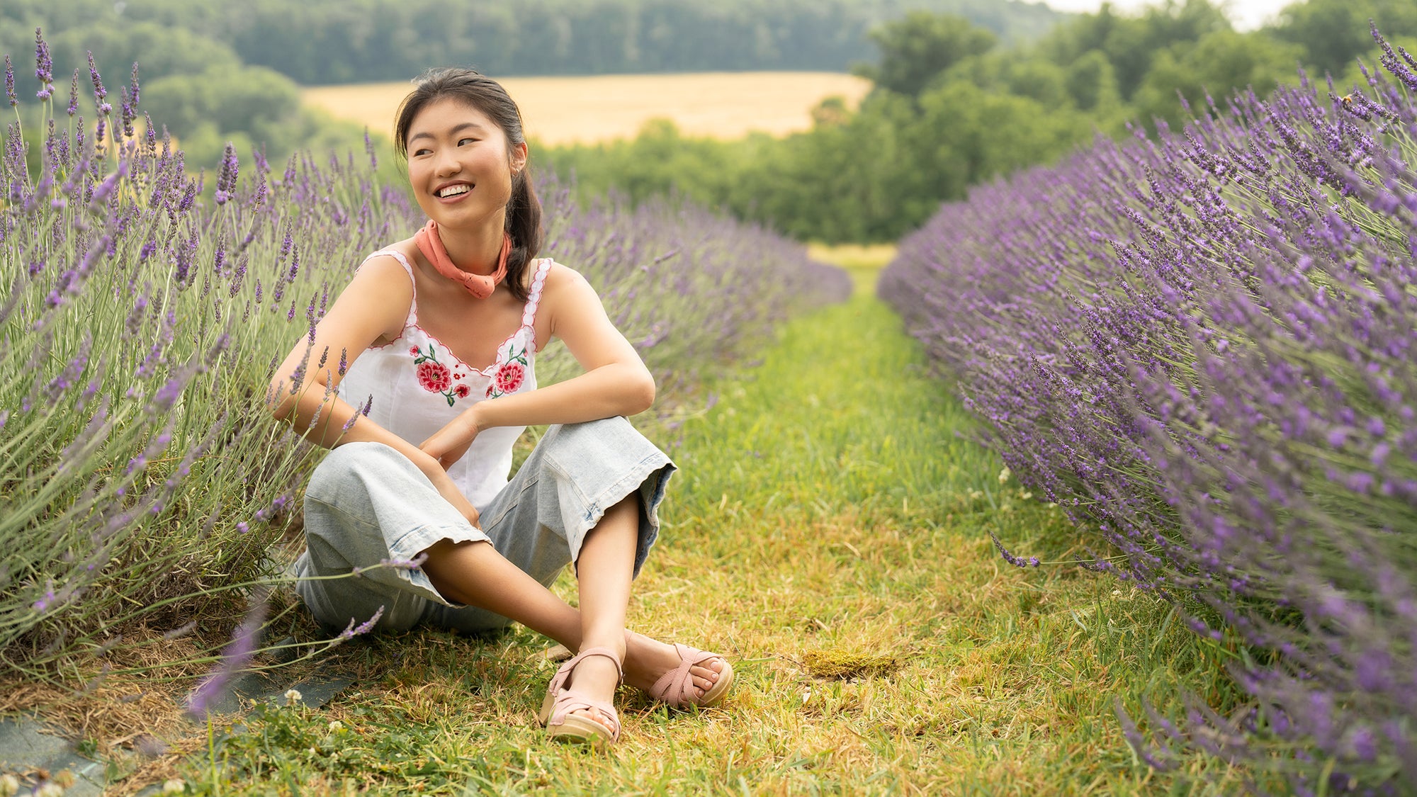 Girl in lavender field wearing pink sandals.