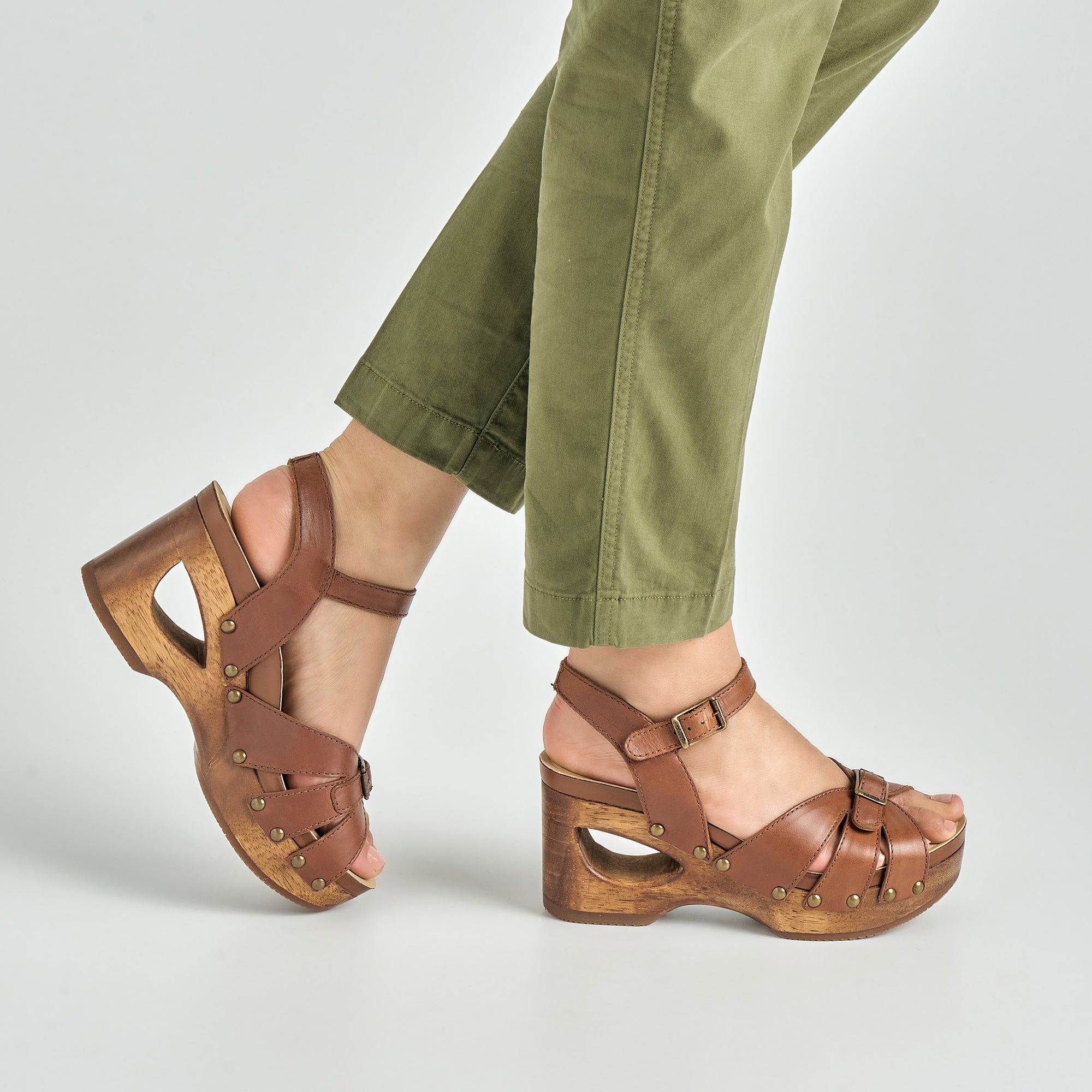 close up of tan wooden heeled mary janes.