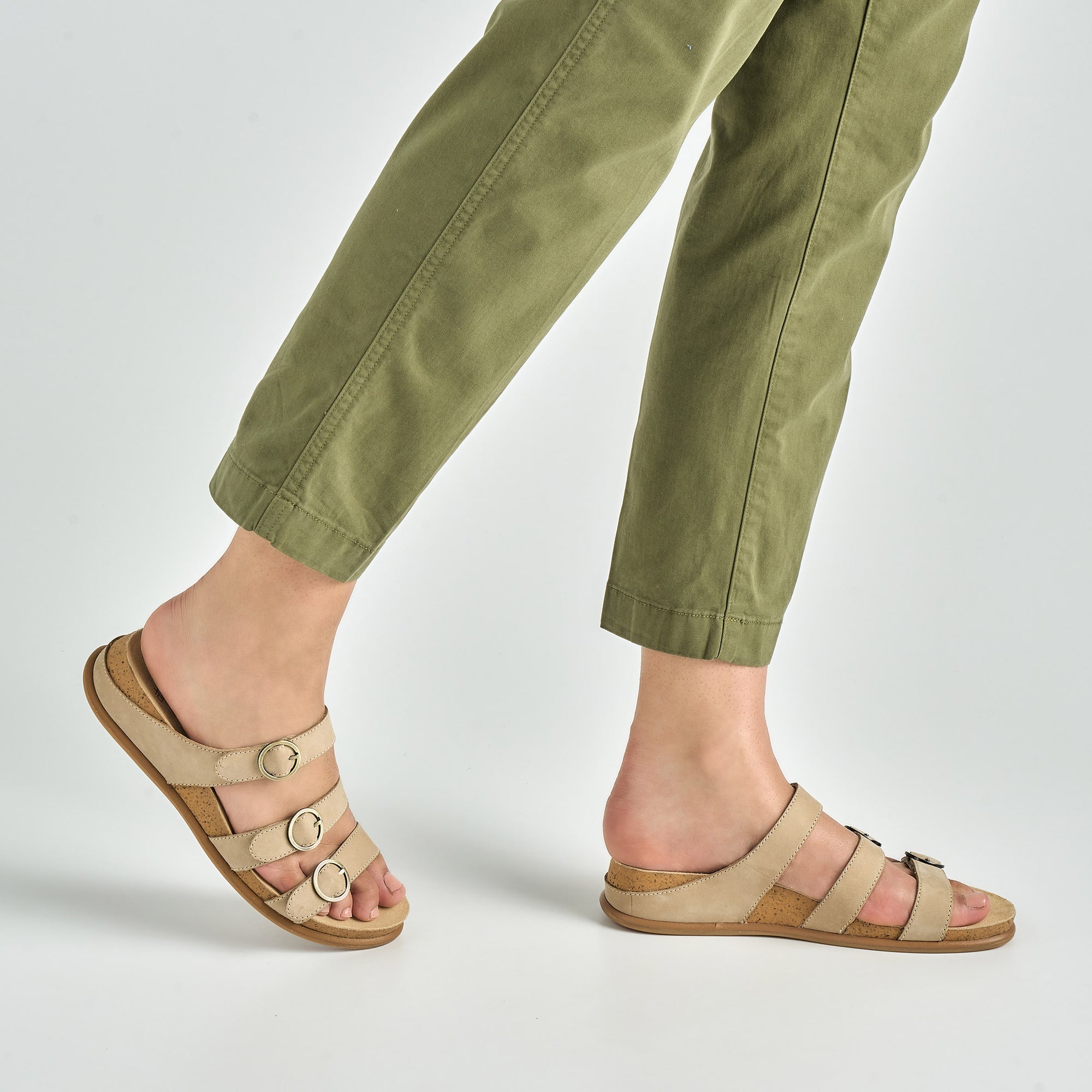 Close up of tan flat strappy sandals.