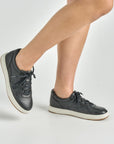 Close up of black leather sneaker.