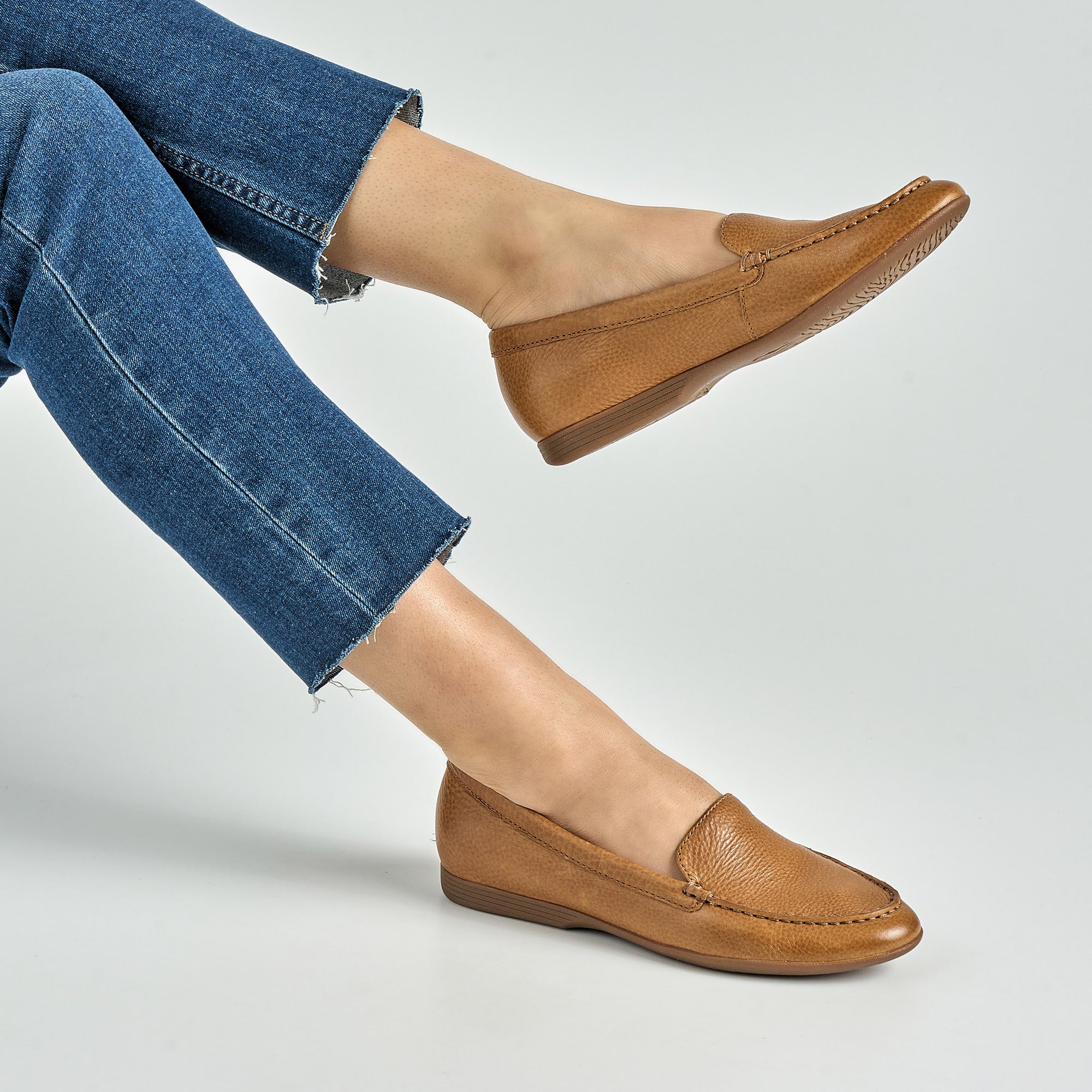 Close up of tan loafers.