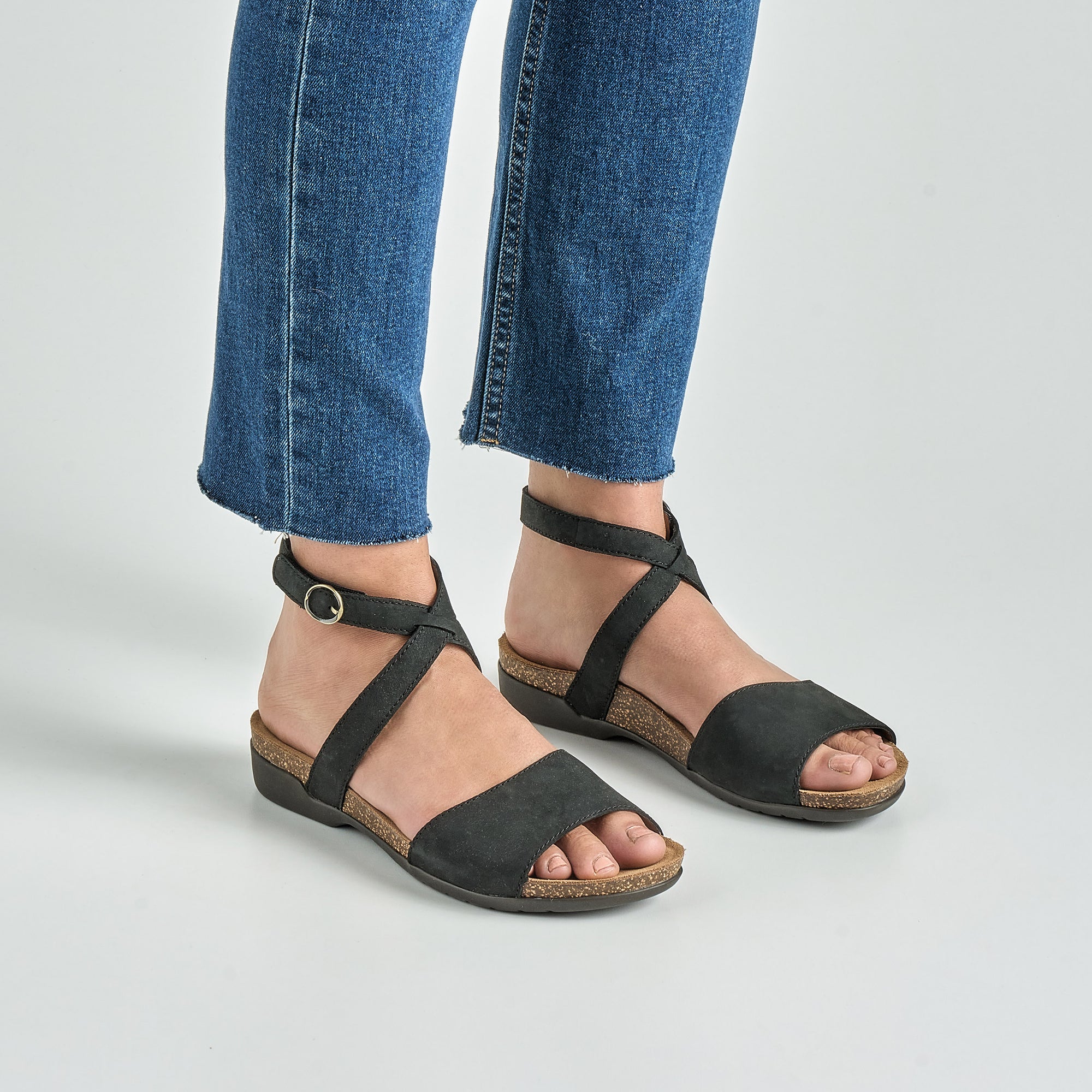 Close up of black flat sandals.