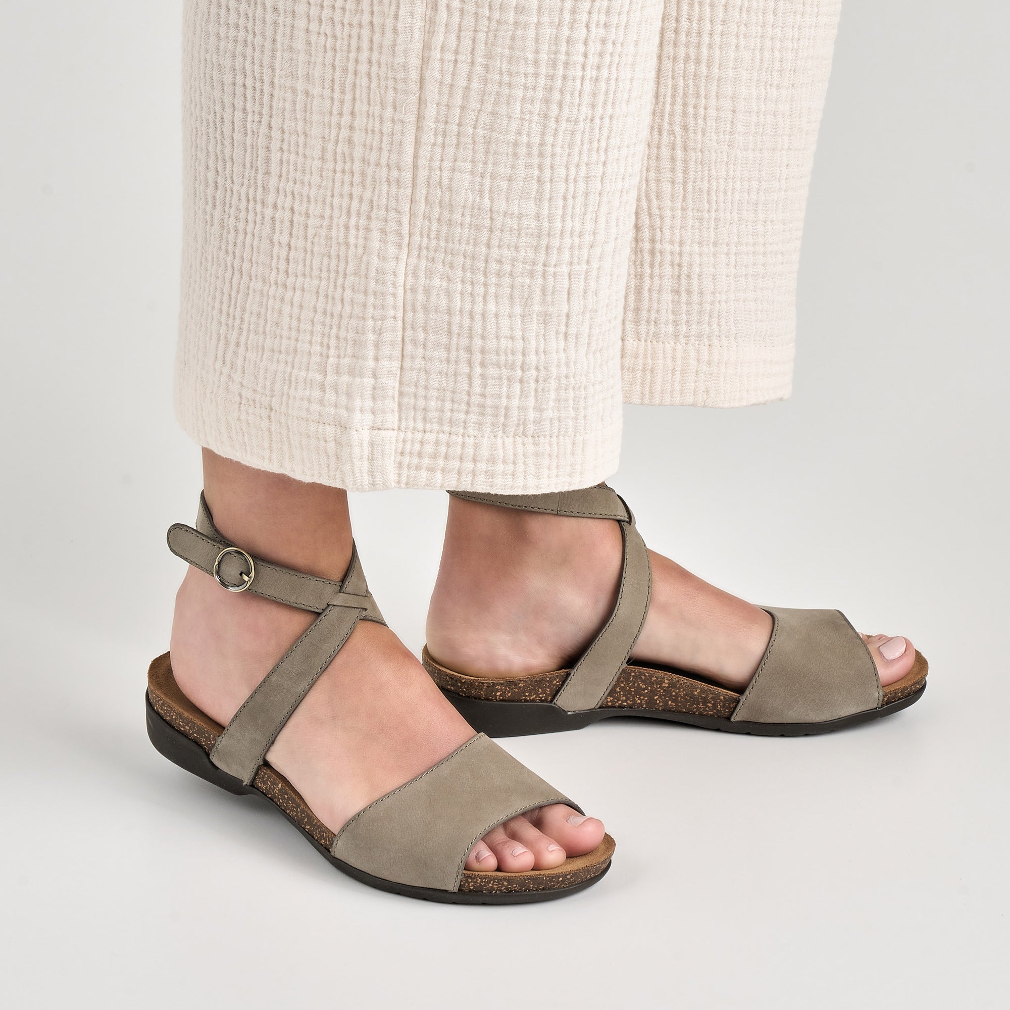 Close up of taupe flat sandals.