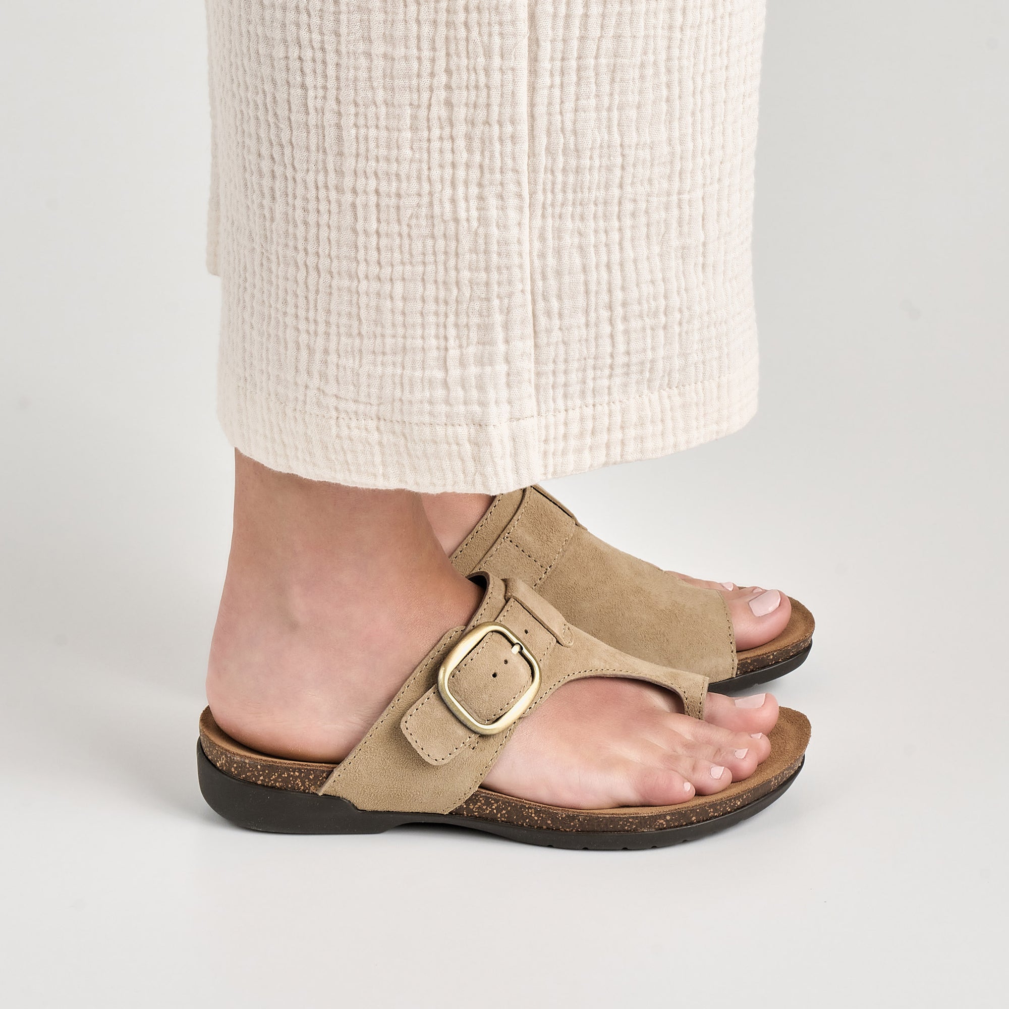 Close up of sand Dansko sandals.