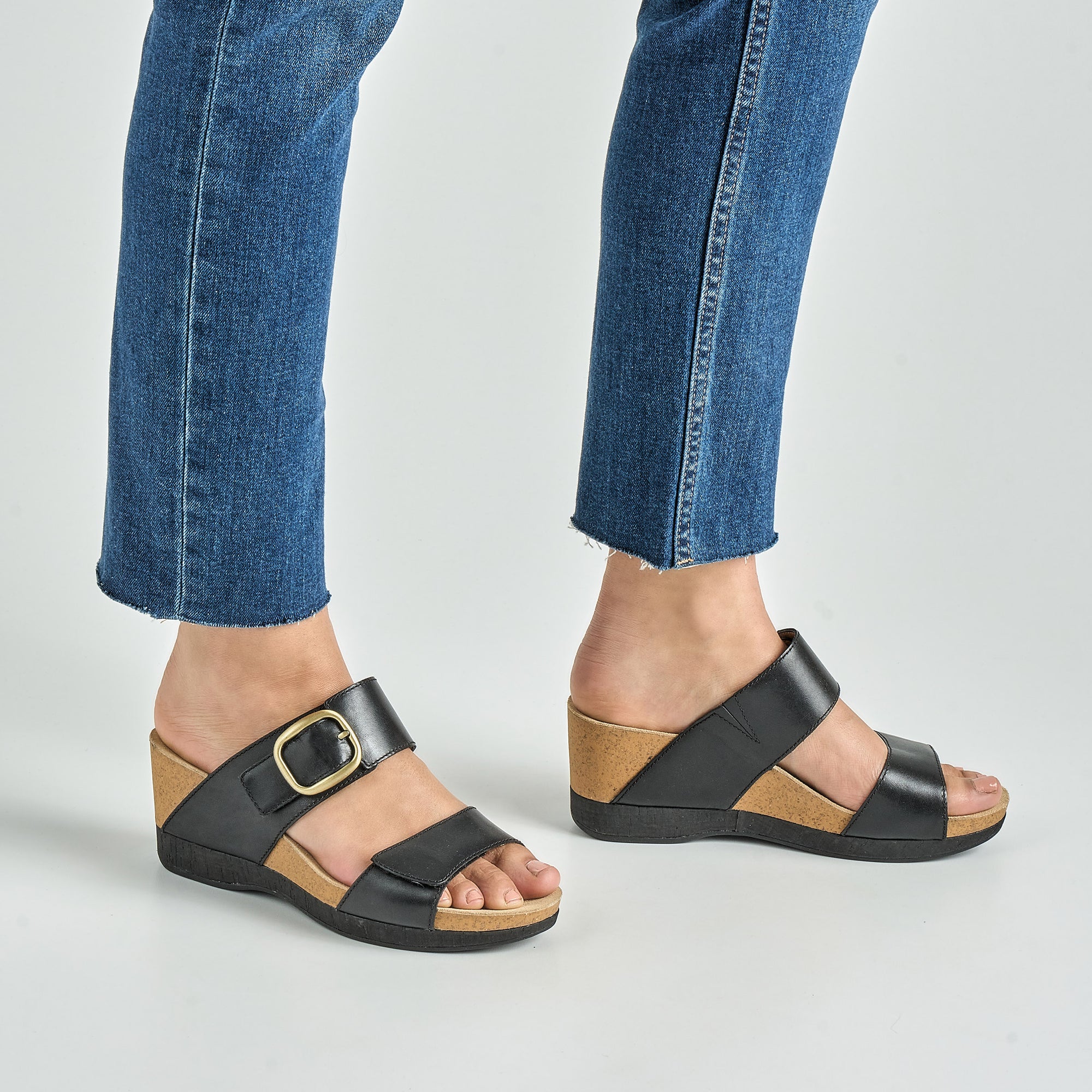 Close up of black wedged sandals.