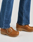 Close up of tan clog with large buckle.