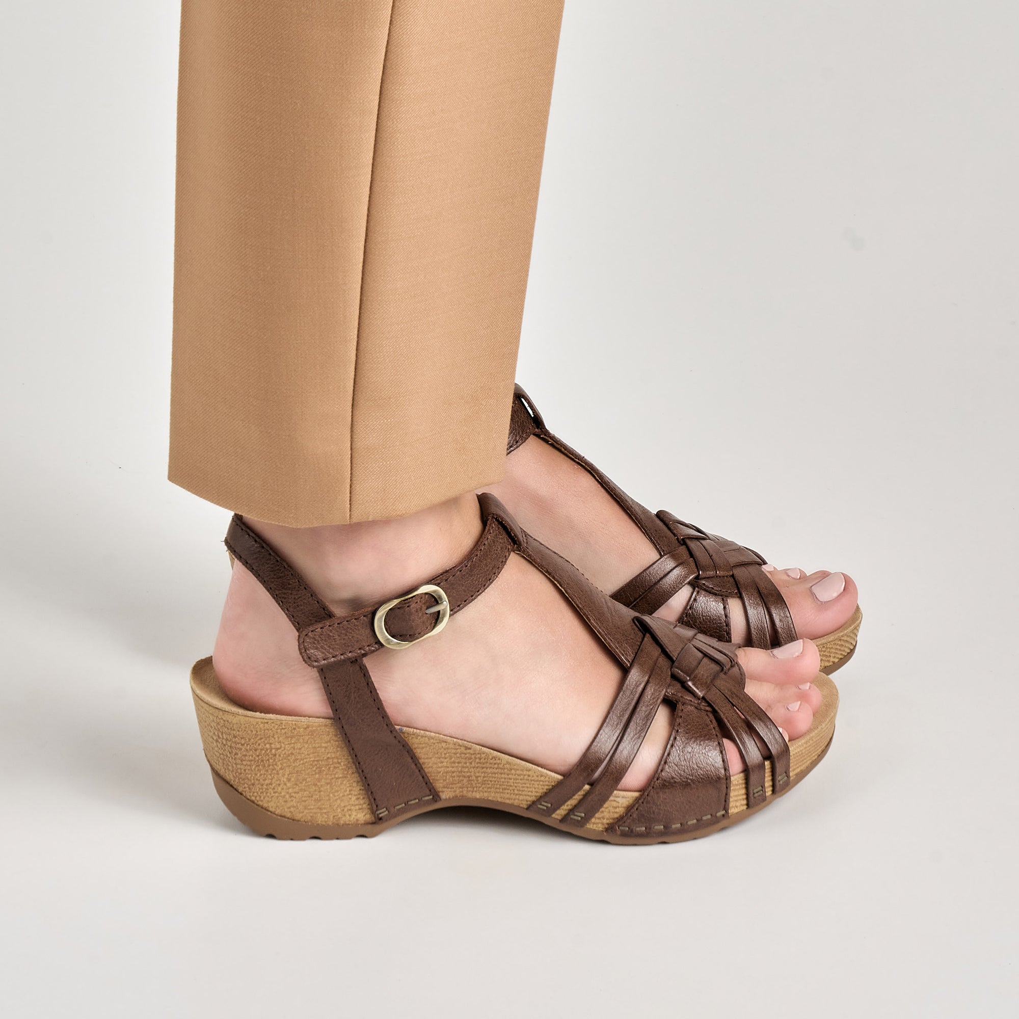 Close up of intricate brown heeled sandals.