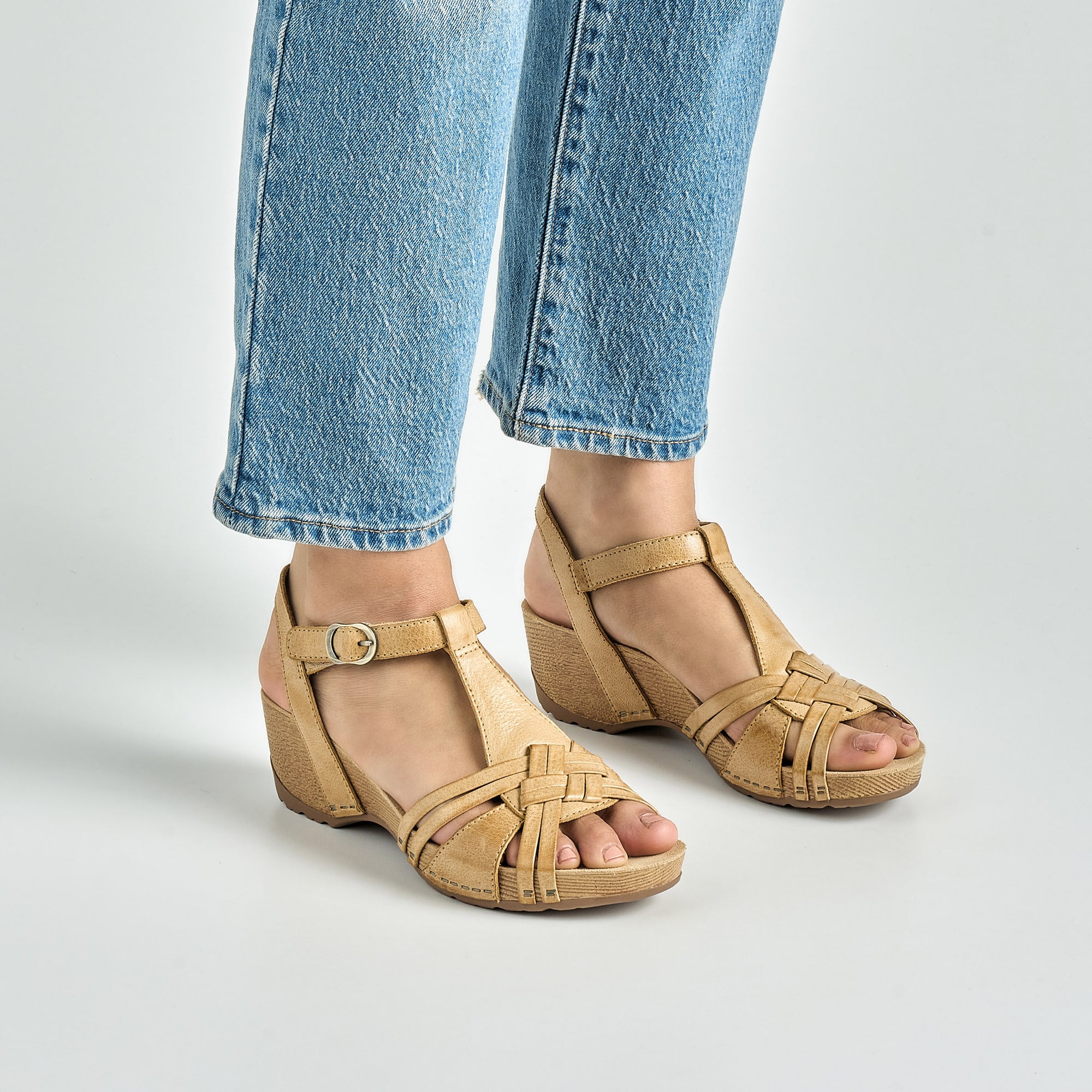 Close up of tan intricate heeled sandals.