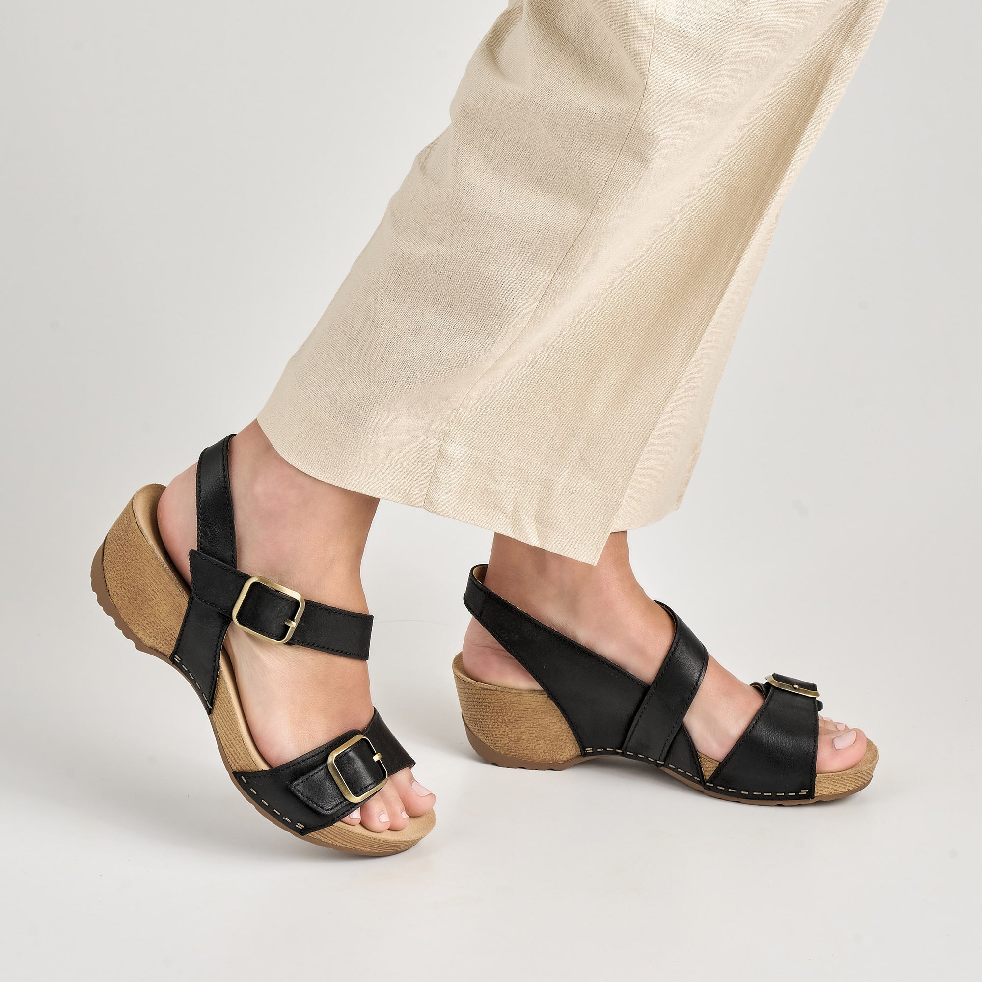 Close up of black heeled sandals.