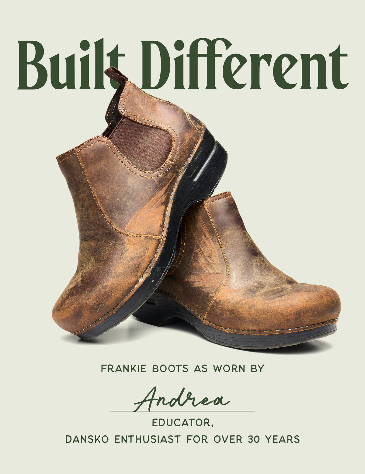 A pair of distressed brown leather Chelsea-style ankle boots shown on a light warm gray background with large dark green text reading 'Built Different' and smaller text below crediting Andrea, an educator, for wearing the boots.