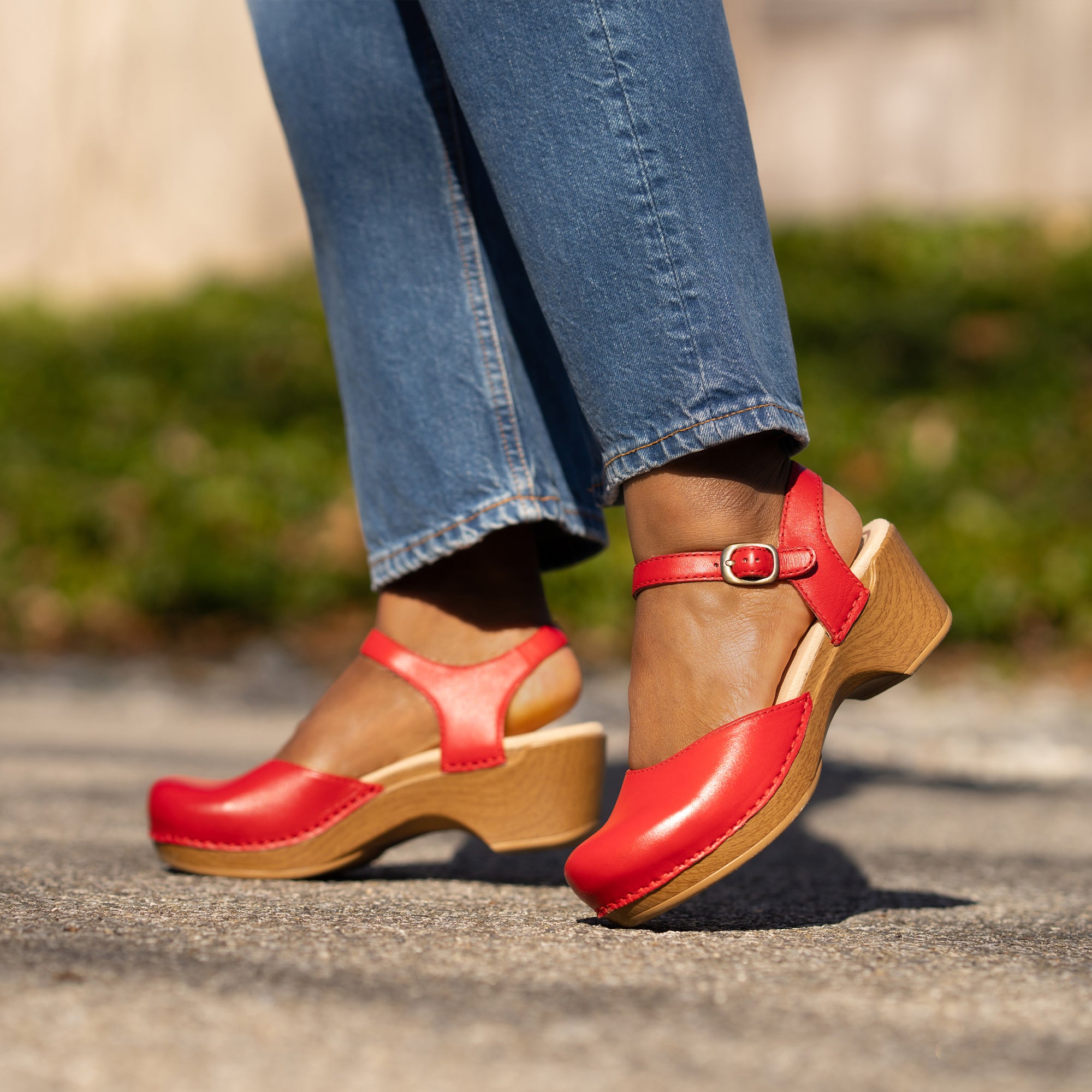 Red Mary Jane clog sandals shown on foot.