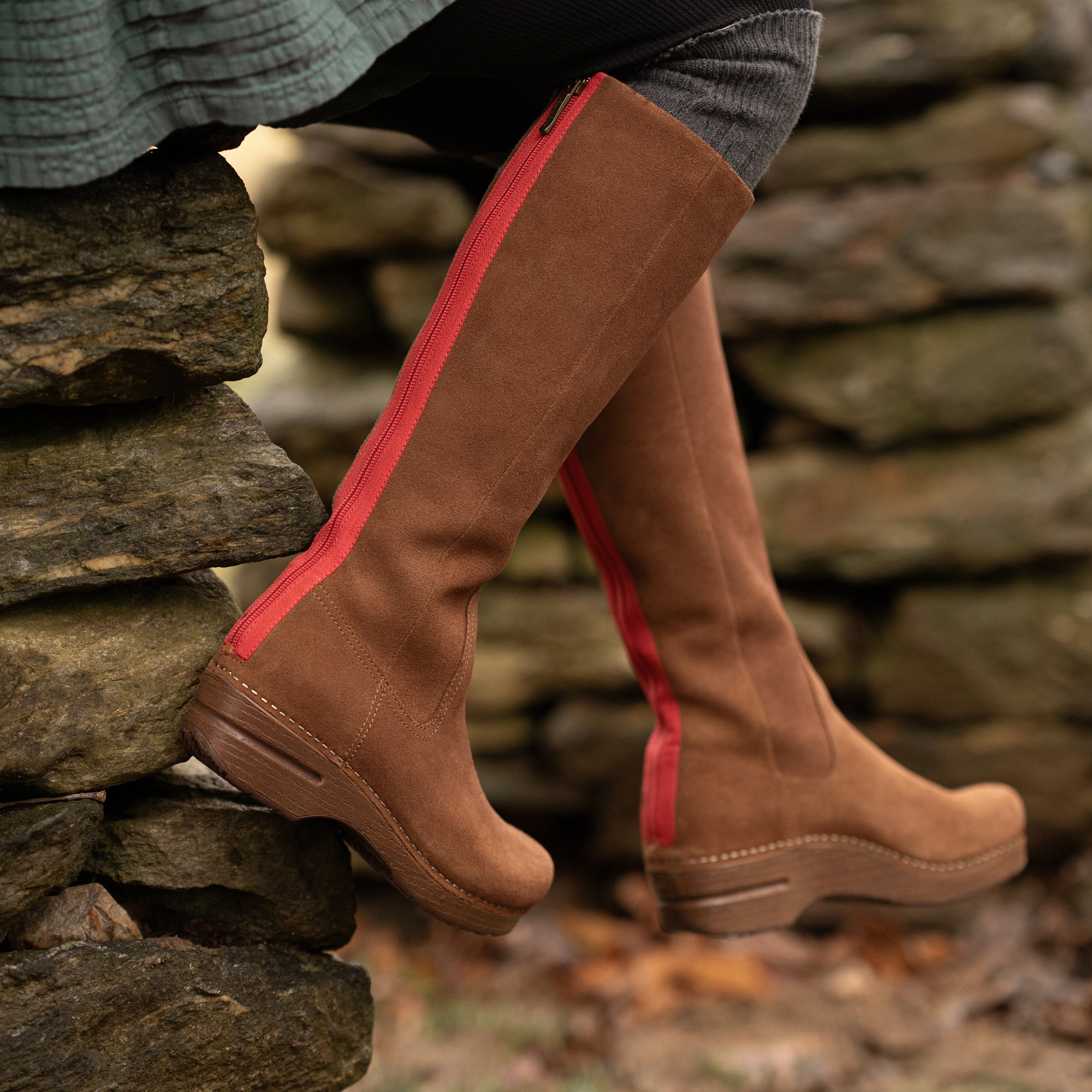 An on-foot look at brown tall-shaft boots with a rocker bottom.