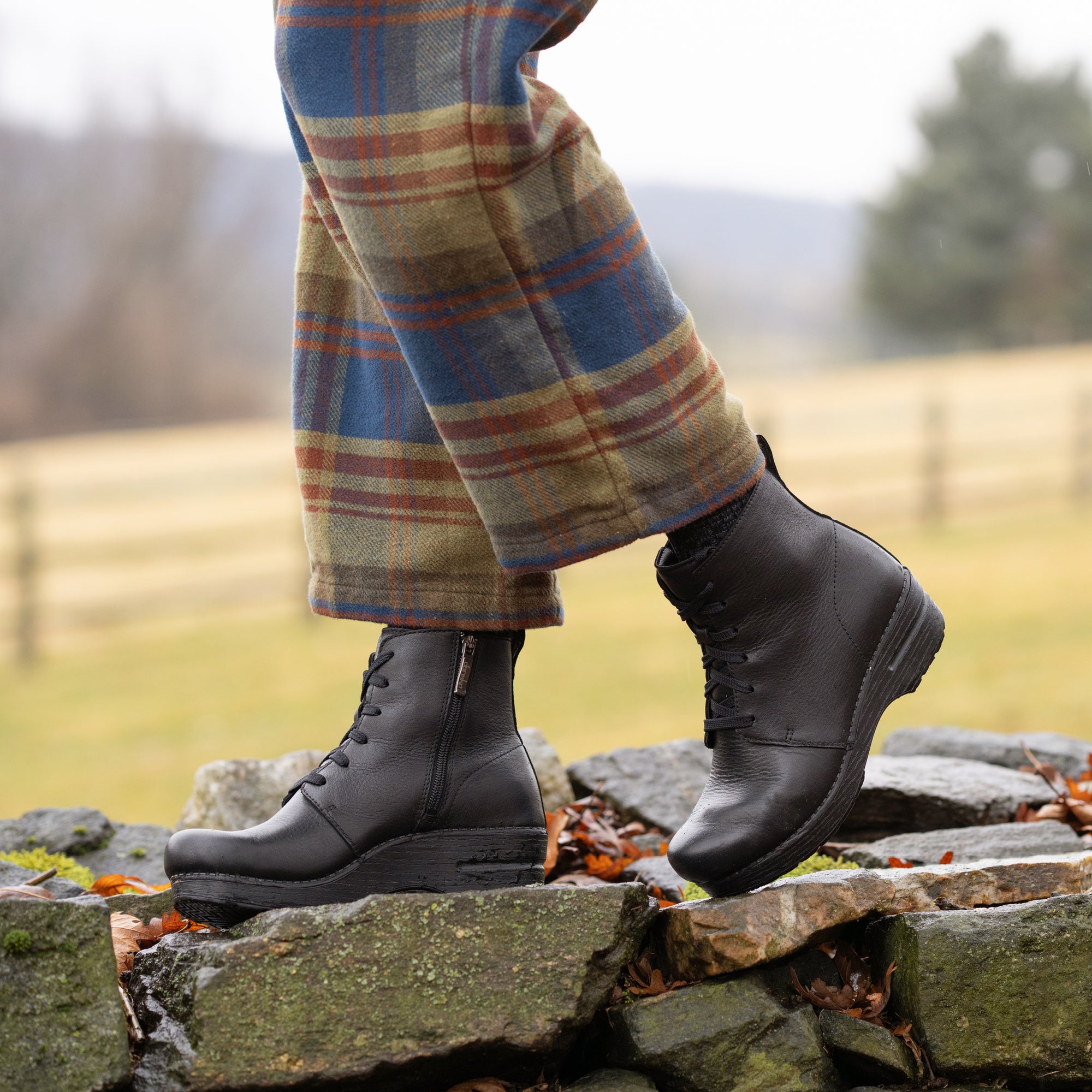 An on-foot look at black combat booties with an inside zipper.