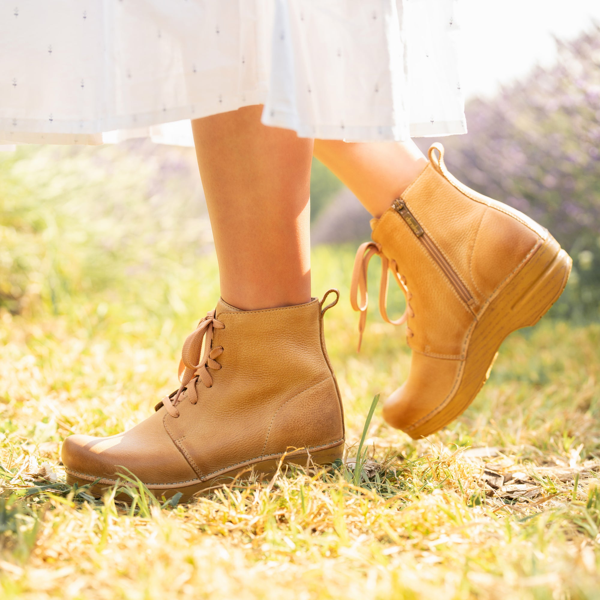 An on-foot look at tan combat booties with inside zipper.