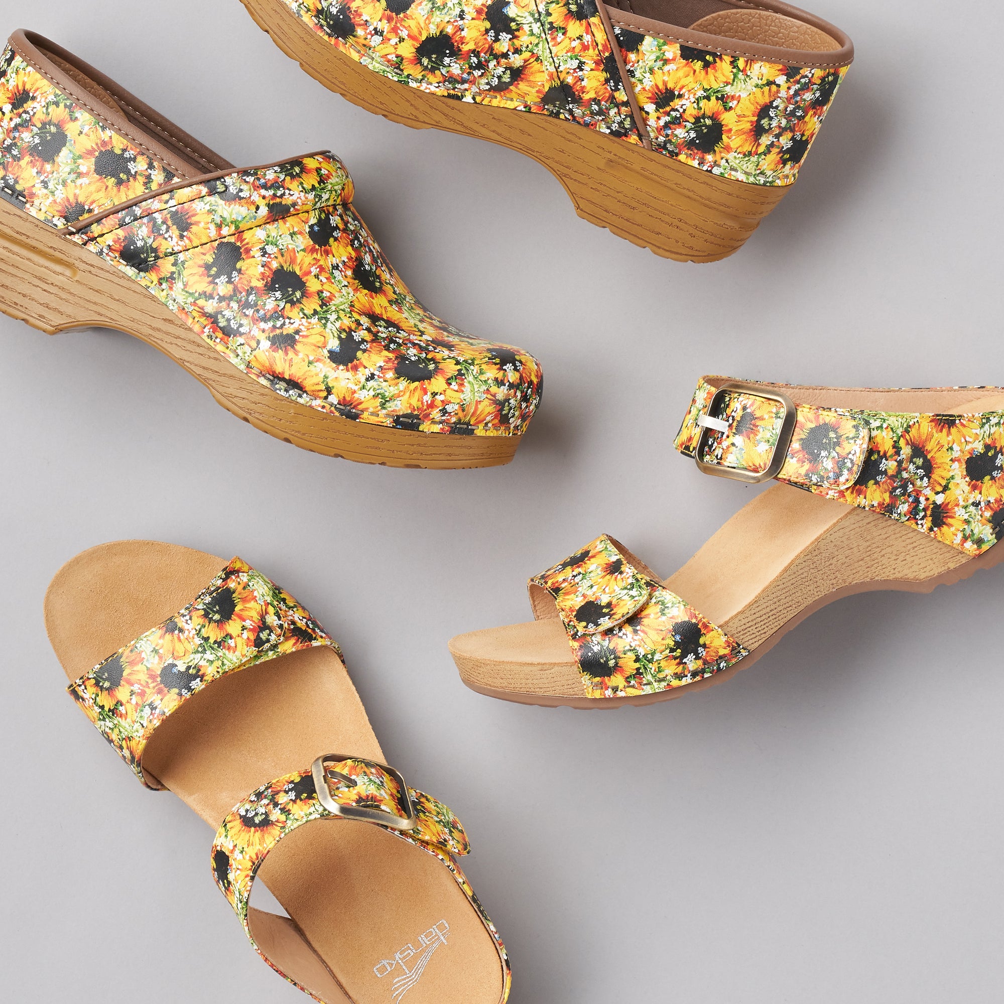 A sunflower printed collection of clog and sandal shown together.