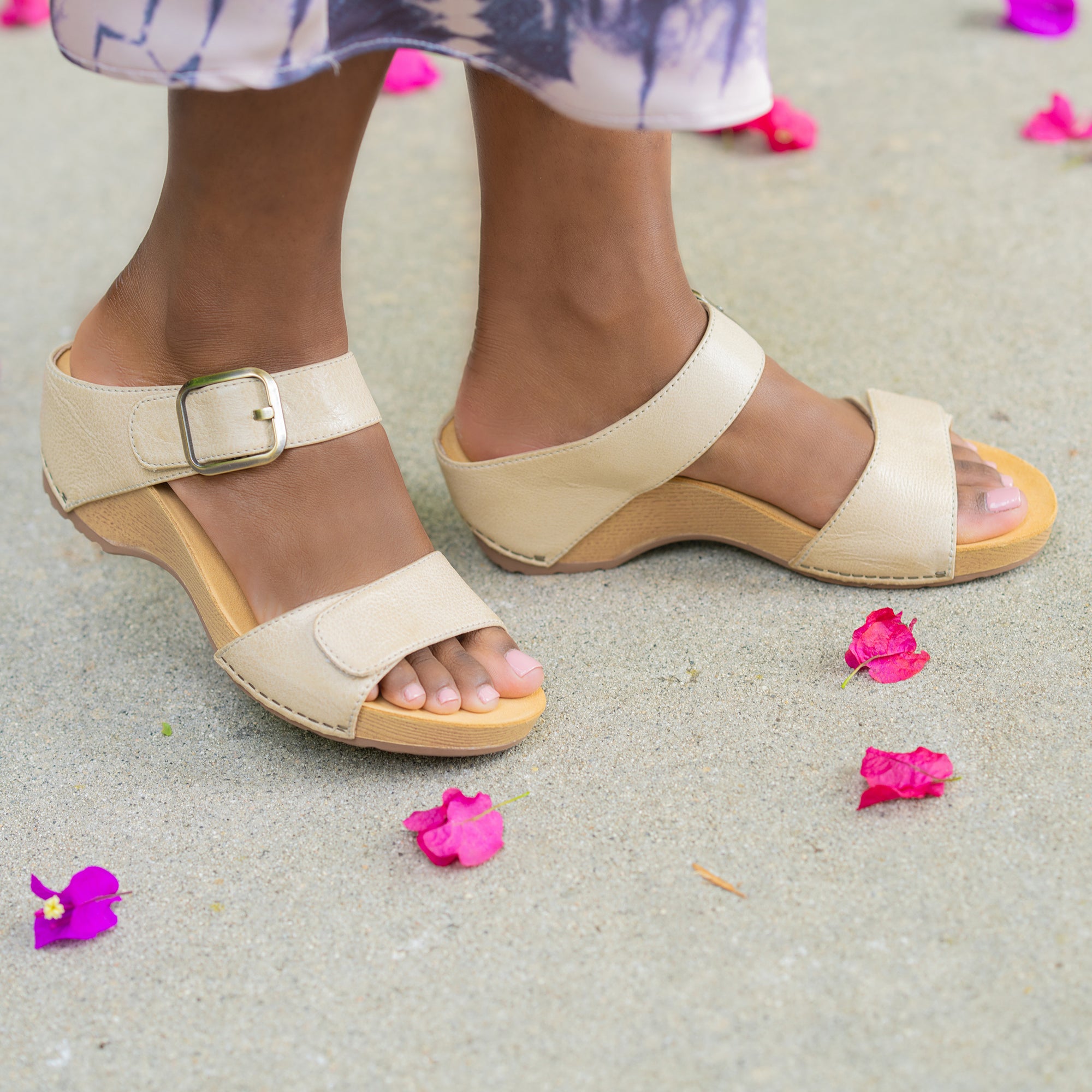 A closeup of tan flatform sandals with a two-strap design.