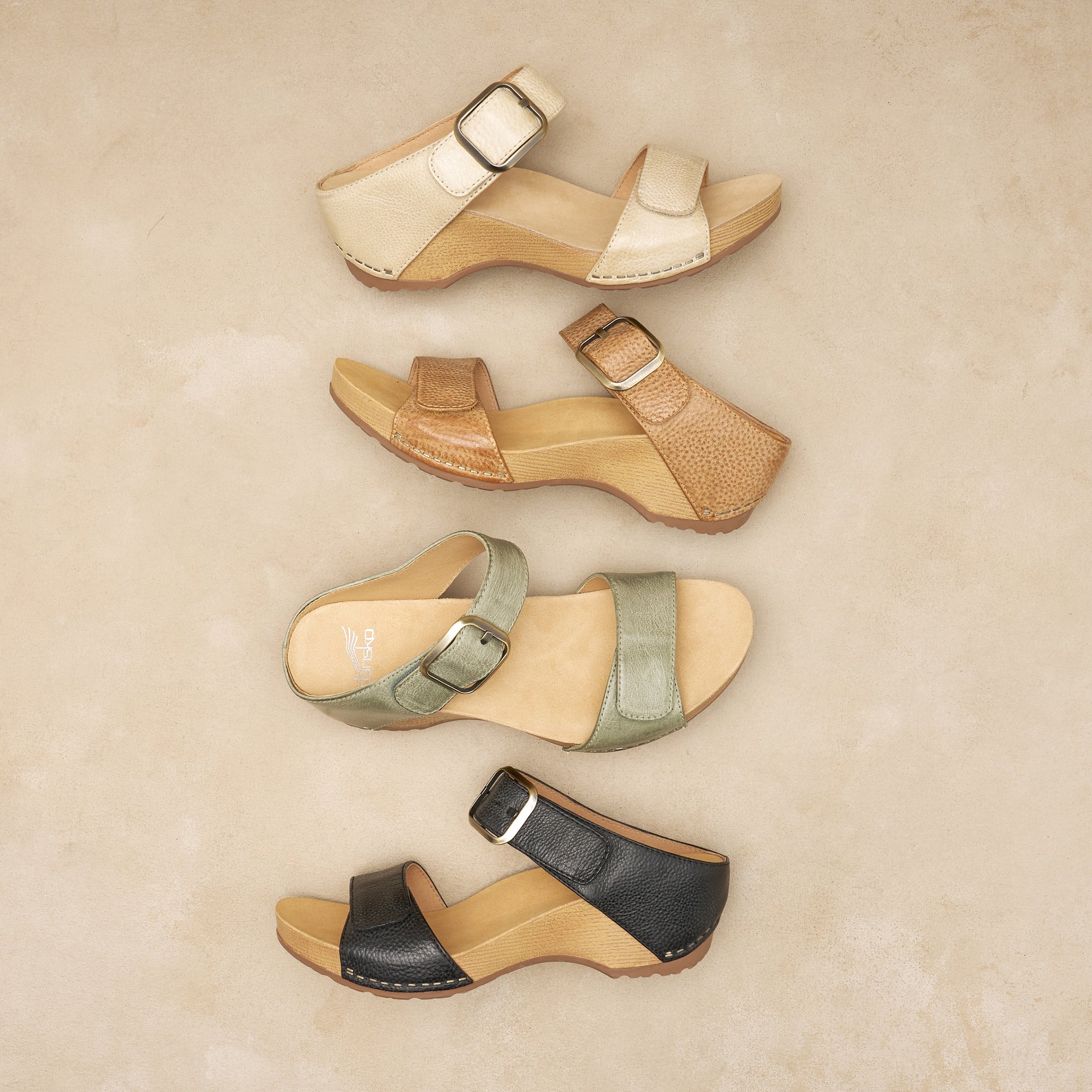 Flat lay of various neutral colored wedge sandals.