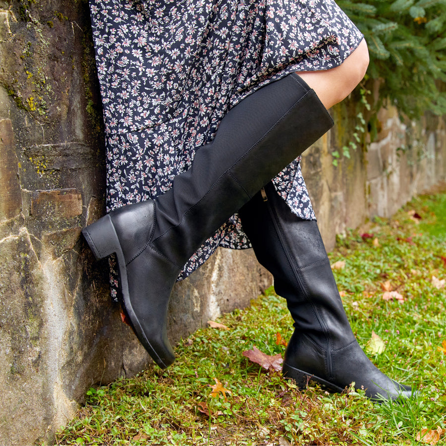 Tall-shaft boots in black are waterproof and comfortable