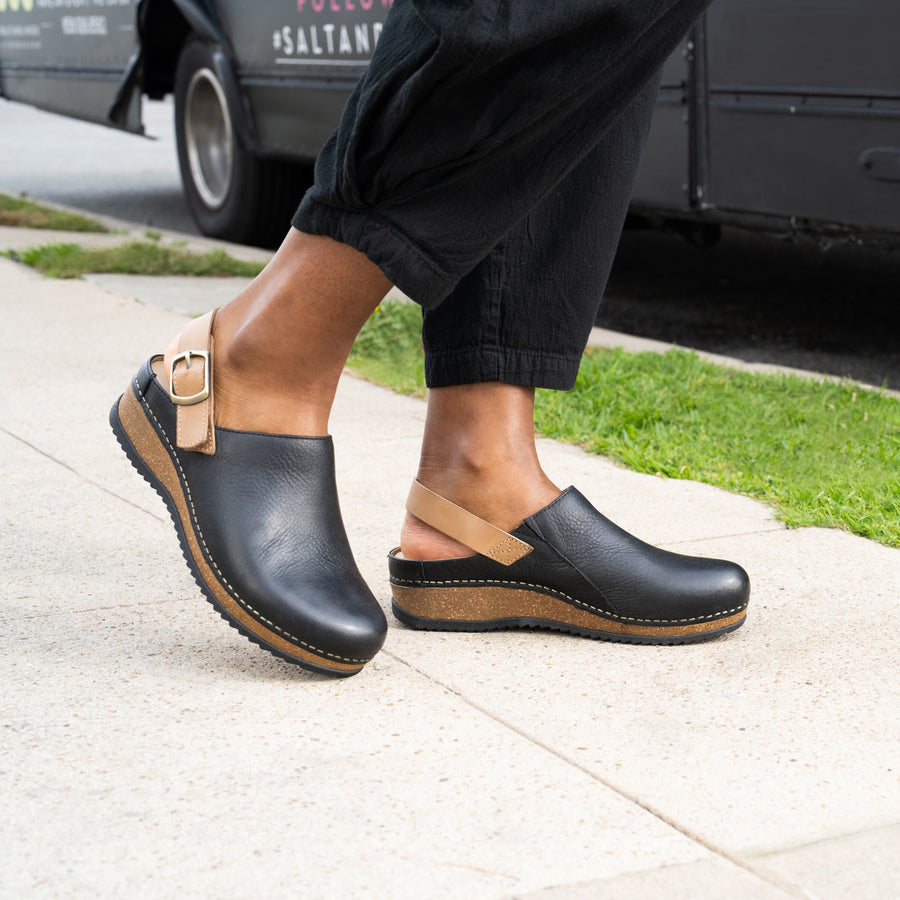 Merrin in black is a trendy and stylish clog made with high-quality materials like leather and cork for style that lasts all year.